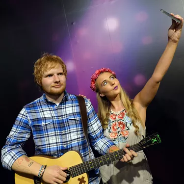 Woman takes a selfie next to Ed Sheeran's wax figure at Madame Tussauds Blackpool