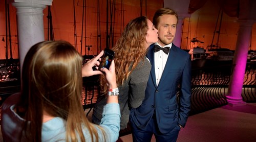 Guest pretending to kiss Ryan Gosling at Madame Tussauds Orlando