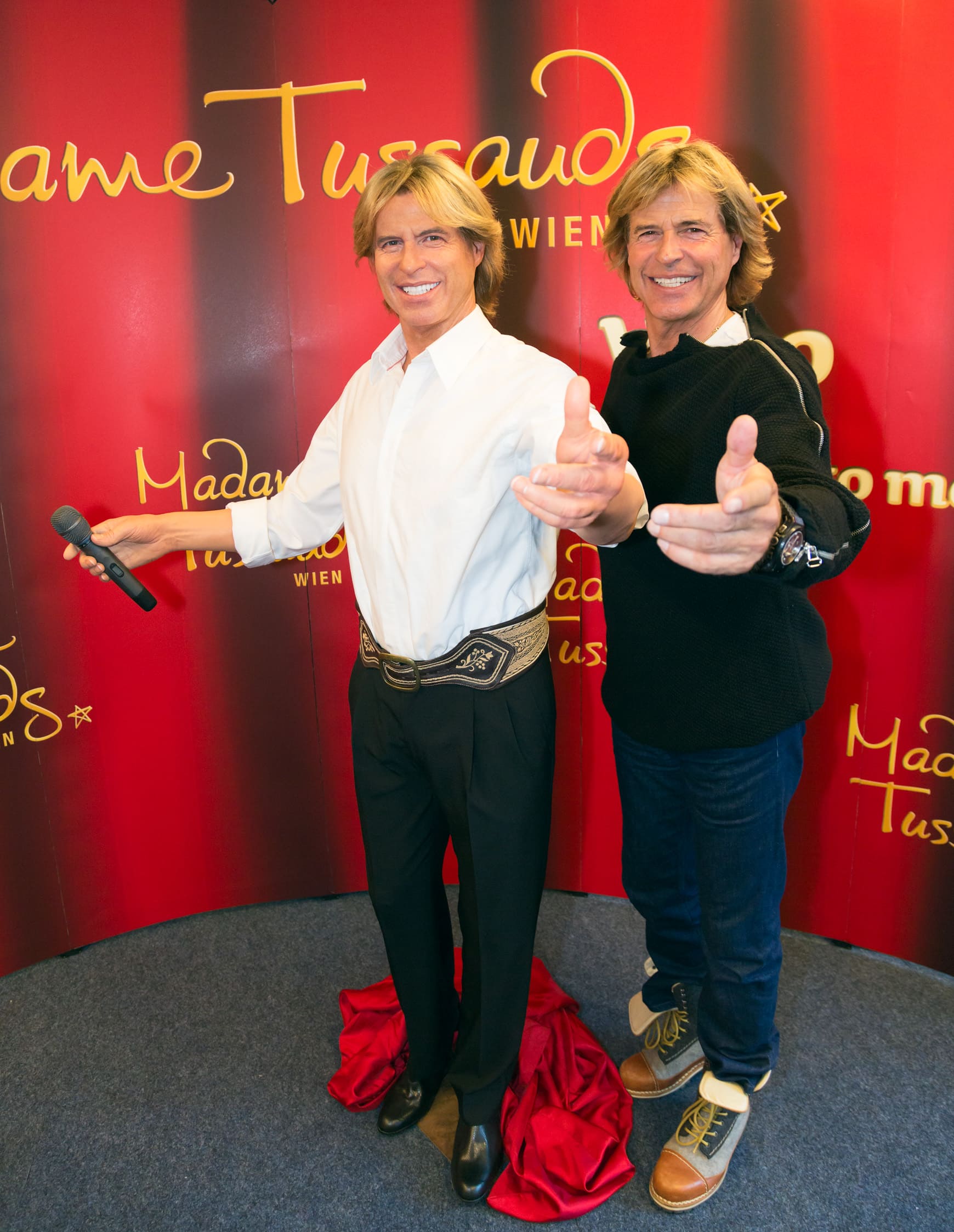 Hansi Hinterseer poses with his wax figure at Madame Tussauds™ Vienna