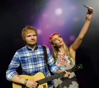 Woman takes a selfie next to Ed Sheeran's wax figure at Madame Tussauds Blackpool