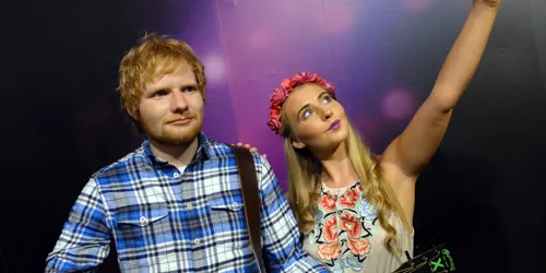 Woman takes a selfie next to Ed Sheeran's wax figure at Madame Tussauds Blackpool