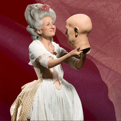 Madame Tussaud herself holding a wax head figure