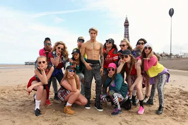 A group of girls surrounds Justin Bieber's wax figure on Blackpool's Beach Promenade 
