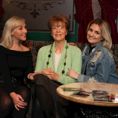 Guests sitting with Deidre Barlow's wax figure at Madame Tussauds Blackpool