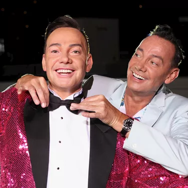 Craig Horwood with his arms around his wax figure at Madame Tussauds Blackpool
