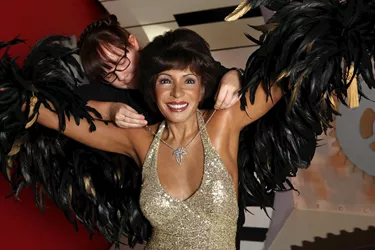 Stylist putting a necklace on Dame Shirley Bassey's wax figure at Madame Tussauds Blackpool