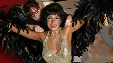 Stylist putting a necklace on Dame Shirley Bassey's wax figure at Madame Tussauds Blackpool