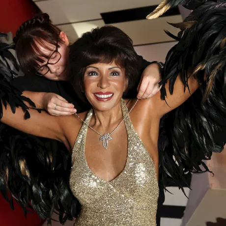 Stylist putting a necklace on Dame Shirley Bassey's wax figure at Madame Tussauds Blackpool