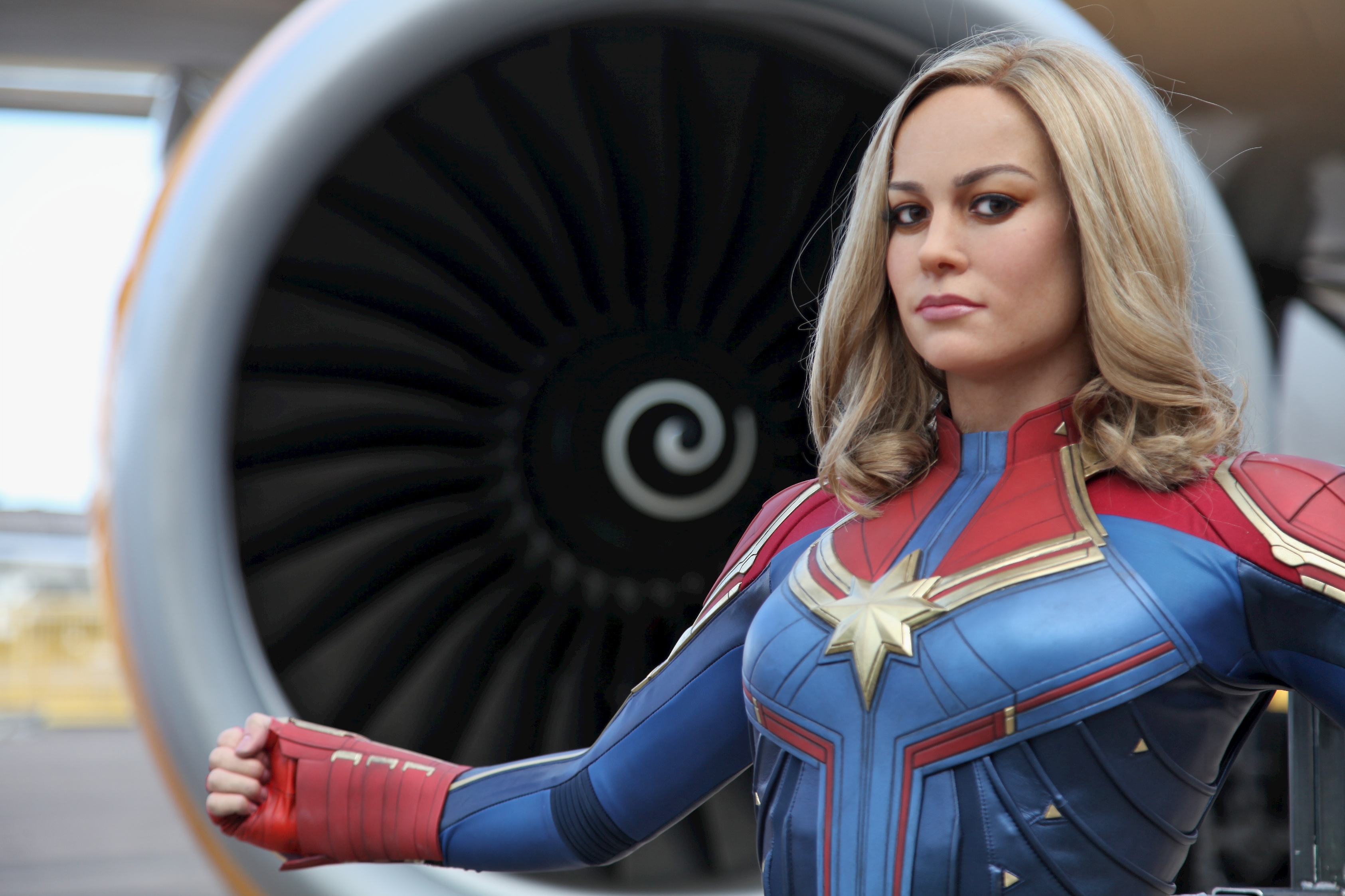 Captain Marvel wax figure in front of an aircraft 