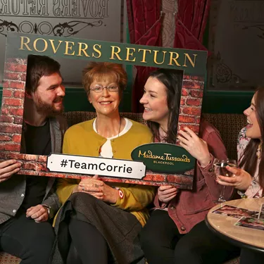 Guests take their photo with Deidre Barlow's wax figure at Madame Tussauds Blackpool