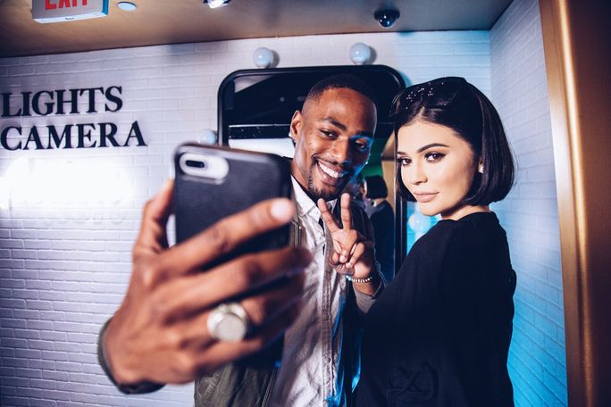 Guest takes a photo with Kylie Jenner