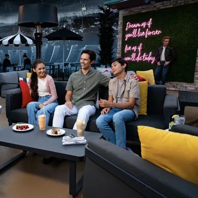 Family eating dessert at The Hollywood Rooftop Restaurant & Bar by Madame Tussauds
