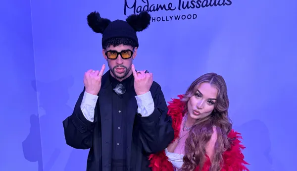 Fan posing with Bad Bunny wax figure at Madame Tussauds Hollywood
