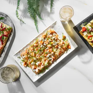 A trio of flatbreads. Smoked salmon flatbread, buffalo chicken flatbread, and grilled steak flatbread.