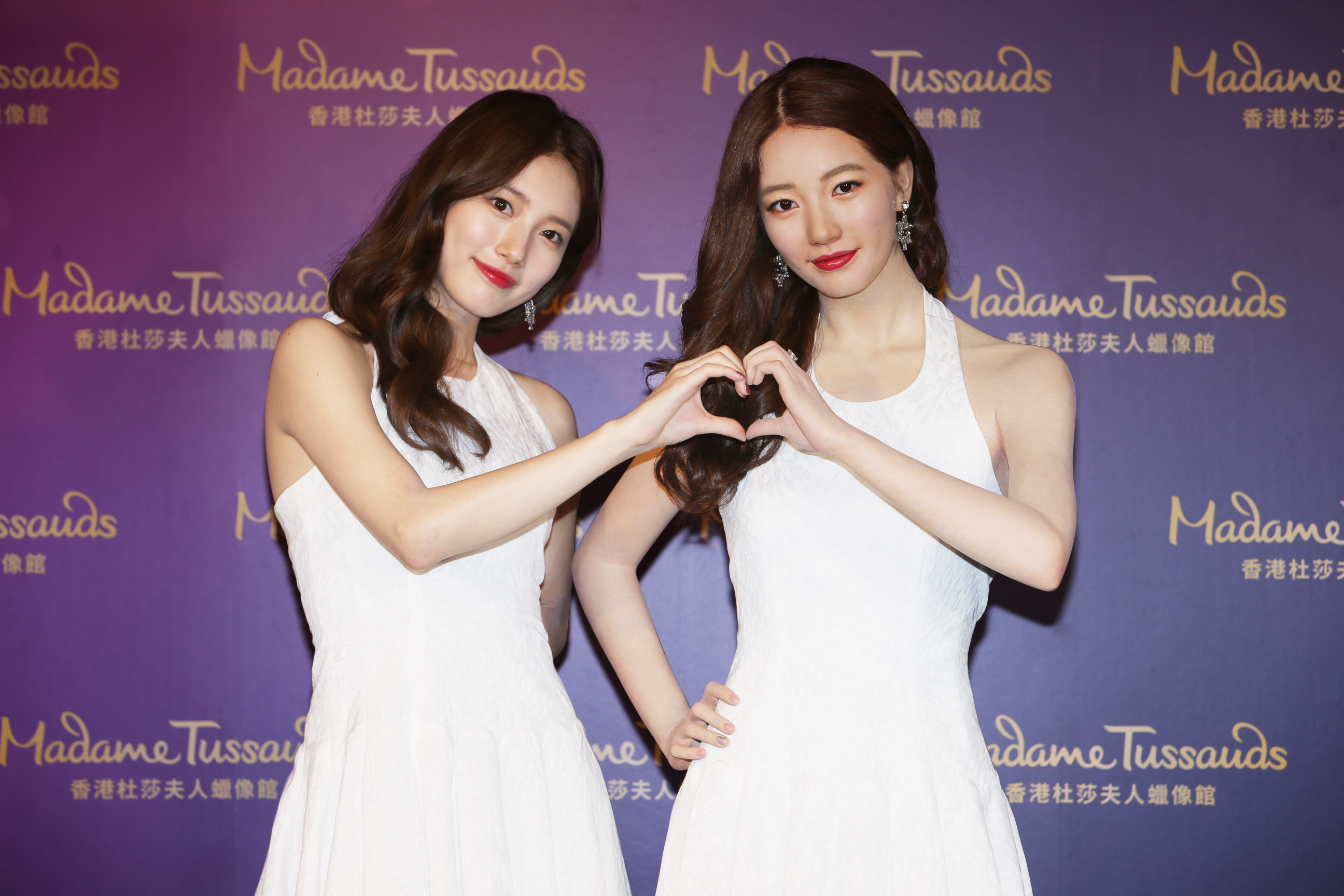 Image of South Korean actress and singer, Suzy, posing with her wax figure at a Madame Tussauds Hong Kong event
