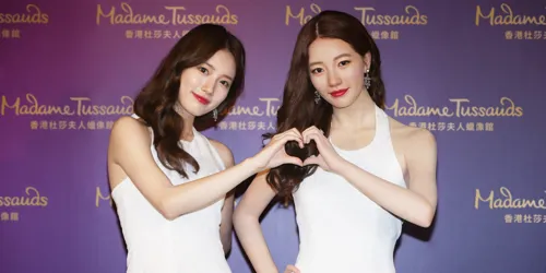 Image of South Korean actress and singer, Suzy, posing with her wax figure at a Madame Tussauds Hong Kong event