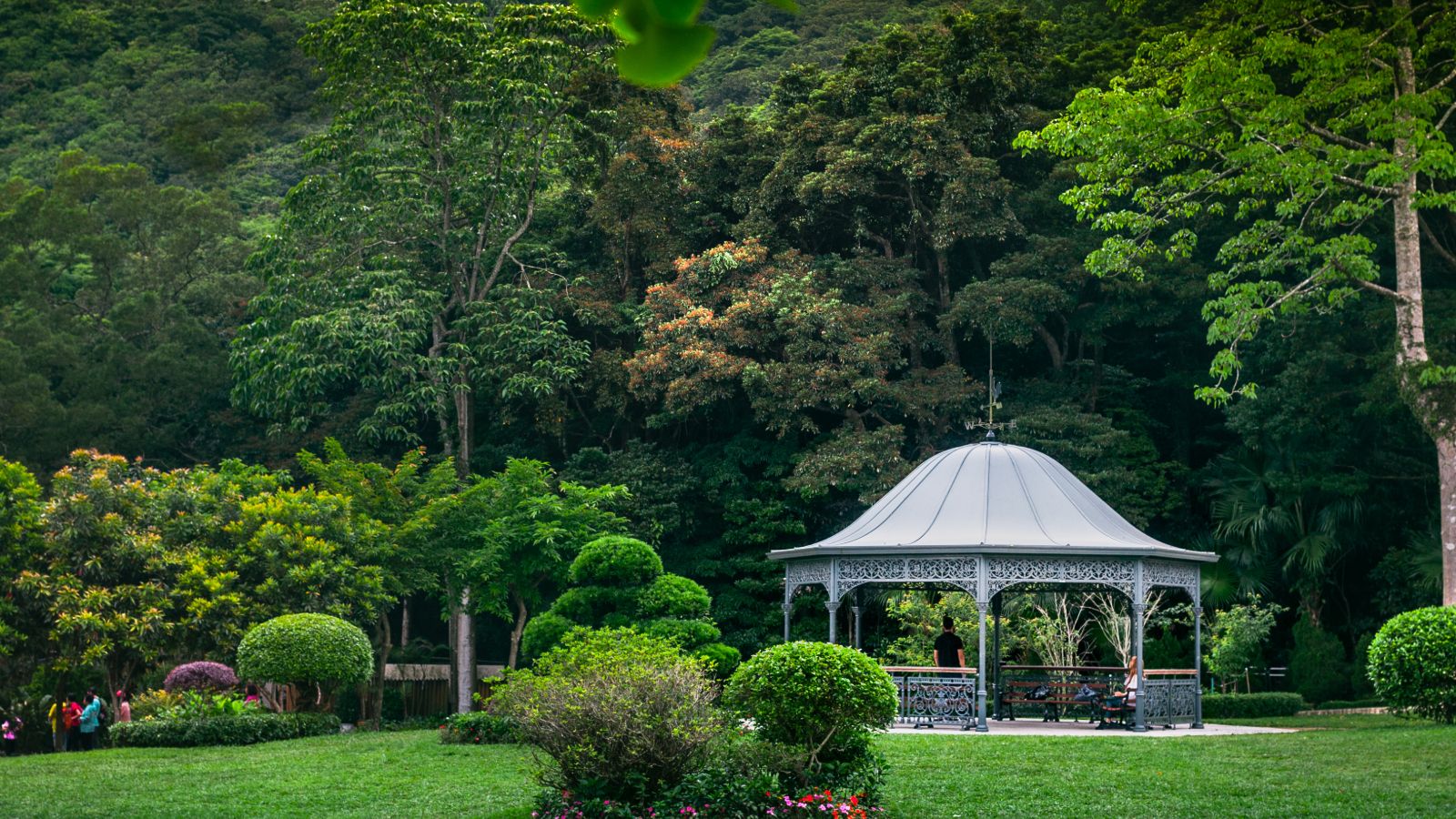 A pavilion nestled in Victoria Peak Garden, offering a tranquil retreat amidst lush greenery and breathtaking views of Hong Kong's skyline and Victoria Harbour.