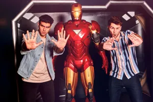 2 people posing next to Iron Man wax figure in Madame Tussauds Hong Kong