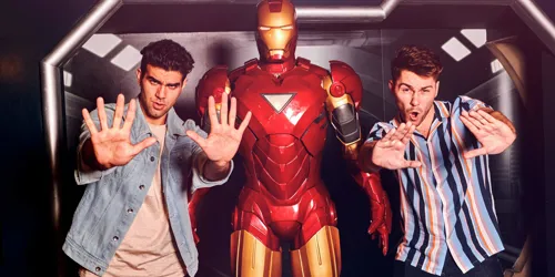 2 people posing next to Iron Man wax figure in Madame Tussauds Hong Kong