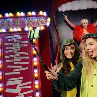 Fans taking a selfie with Miley Cyrus figure