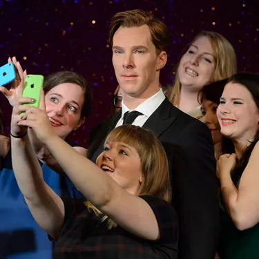 Fans taking a selfie with Benedict Cumberbatch figure at Madame Tussauds