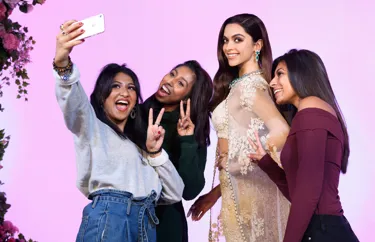 Visitors taking photos with famous figures at Madame Tussauds London.