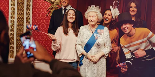 Family with the Queen at Madame Tussauds London
