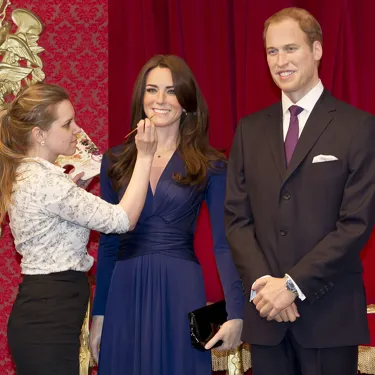 Sculptor touching up Kate & William figures