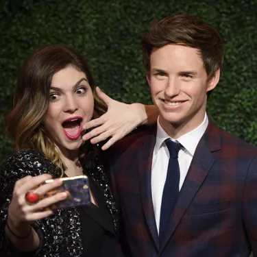 Fan taking a selfie with Eddie Redmayne at Madame Tussauds London