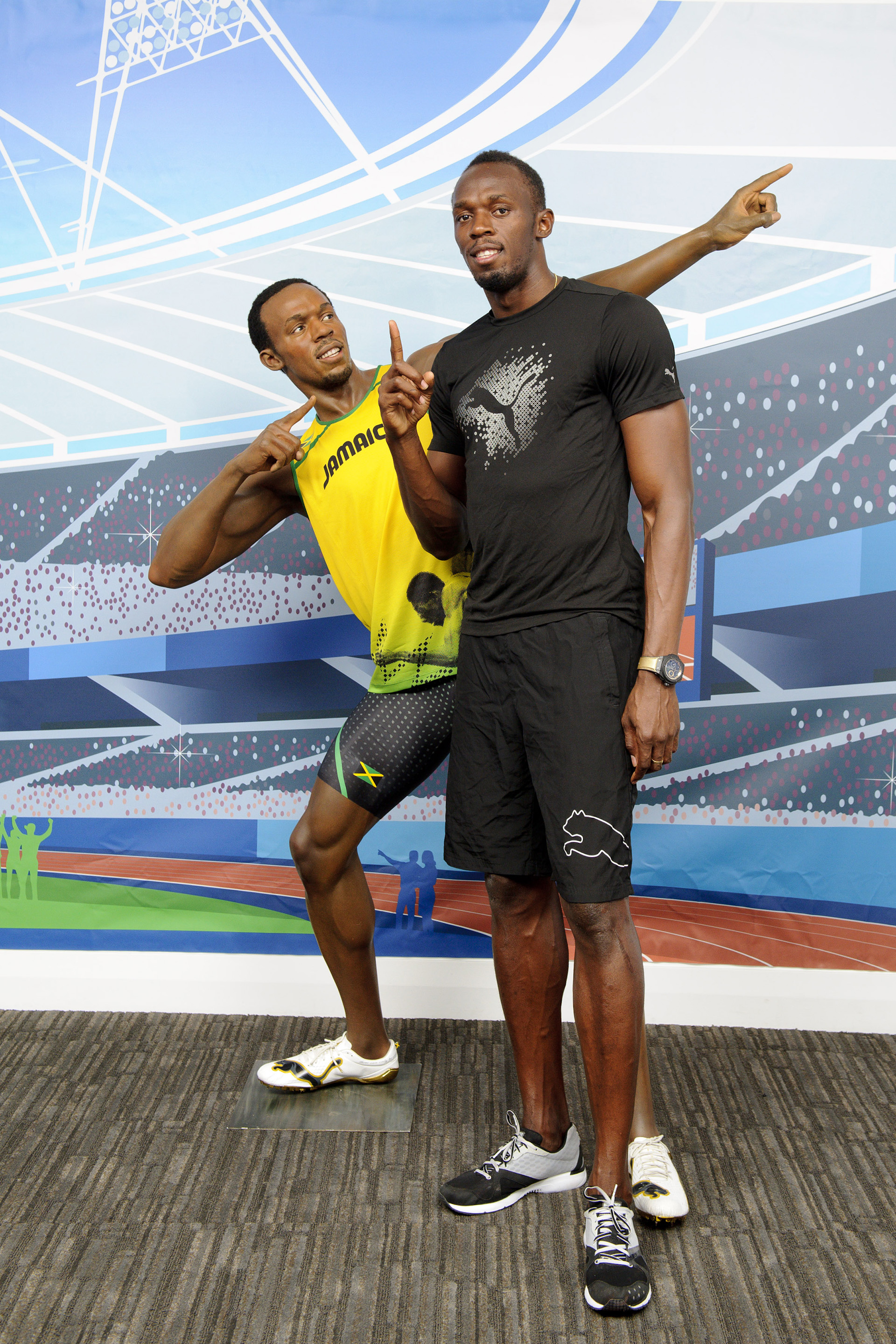 Usain Bolt with his own figure at Madame Tussauds London