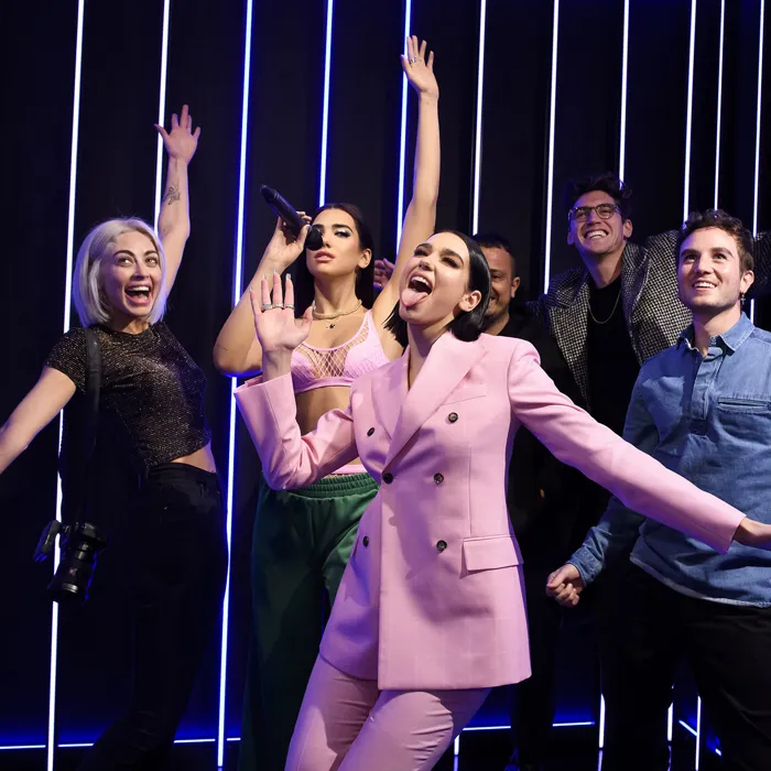 Dua Lipa with her figure and fans at Madame Tussauds