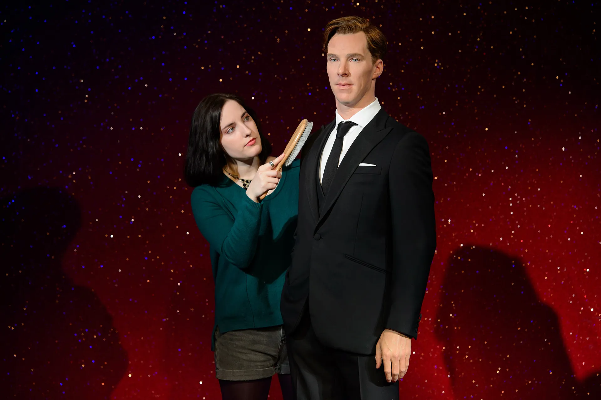 A fan grooming Benedict Cumberbatch figure