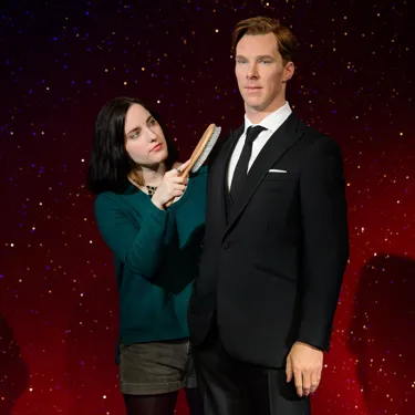 A fan grooming Benedict Cumberbatch figure