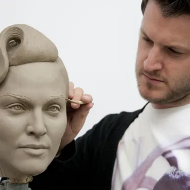 Sculptor working on Madonna sculpture