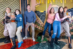 Guests posing with wax figures from the 2016 Ghostbusters movie