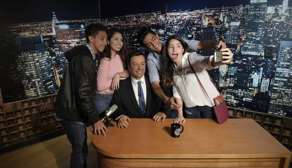 Group of friends taking a picture with Jimmy Fallon at Madame Tussauds New York