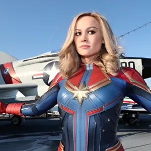 Wax figure of Captain Marvel with a fighter jet behind the figure