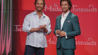 Actor Matthew McConaughey posing next to his wax figure at Madame Tussauds New York