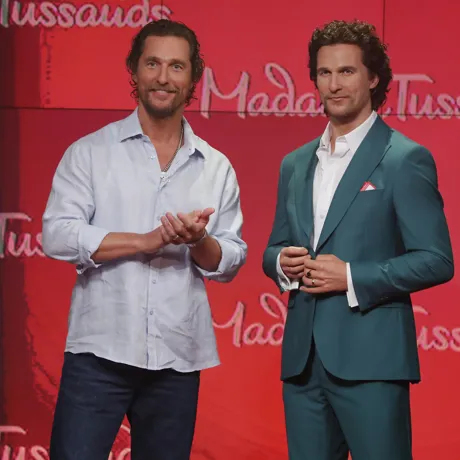 Actor Matthew McConaughey posing next to his wax figure at Madame Tussauds New York