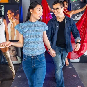 Guests holding hands and enjoying their time in Madame Tussauds New York