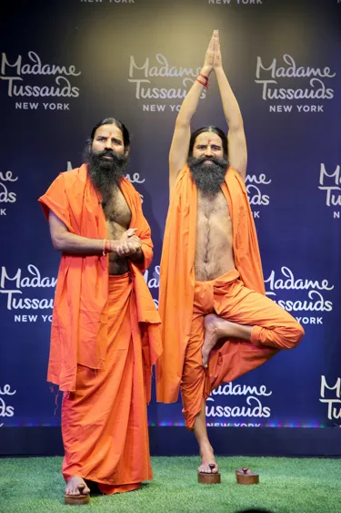 baba ramdev standing next to his wax figure