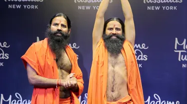 baba ramdev standing next to his wax figure