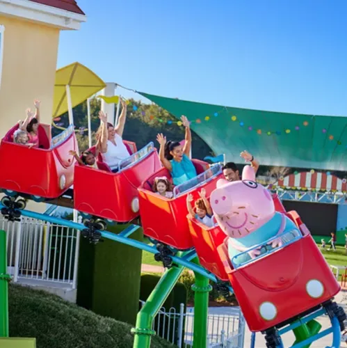 Kids and their parents riding on Daddy Pig’s roller coaster