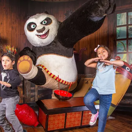 Two kids in kung fu stances along side Po from the movie Kung Fu Panda