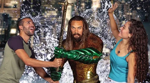 Visitors interacting with Aquaman for a realistic-looking photo