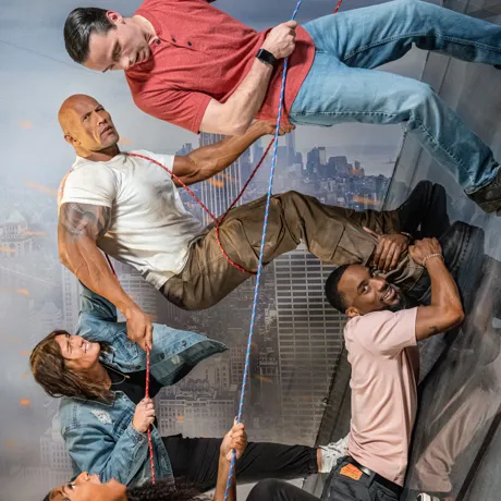 Photo guests posing in the action movie set with Dwayne John's wax figure