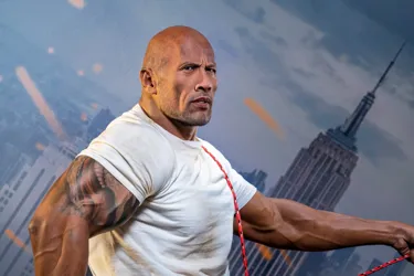 Dwayne Johnson wax figure with an action-packed backdrop for an immersive movie-like experience.