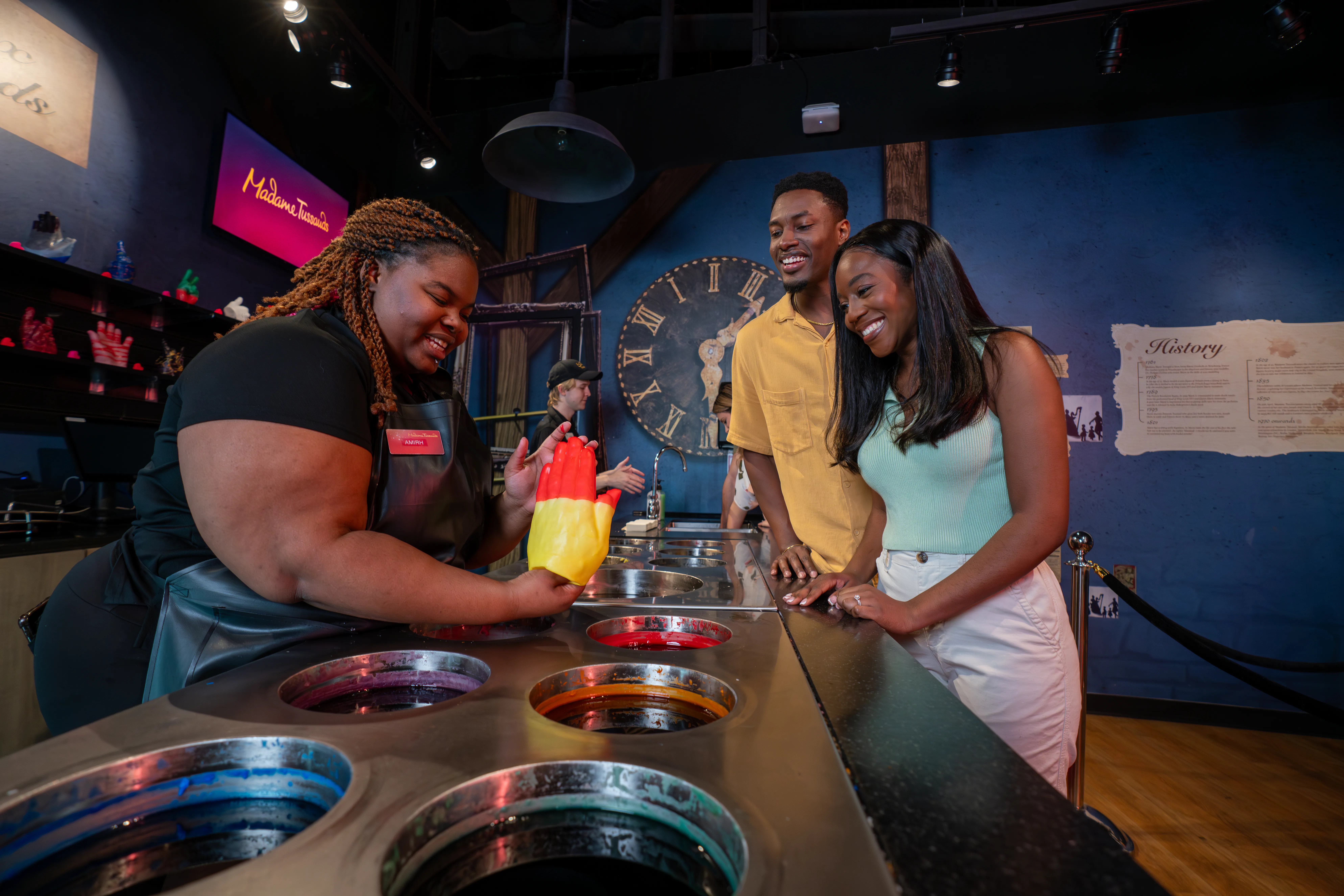 Couple smiles after their wax hands were dipped in red and yellow at Madame Tussauds Orlando.