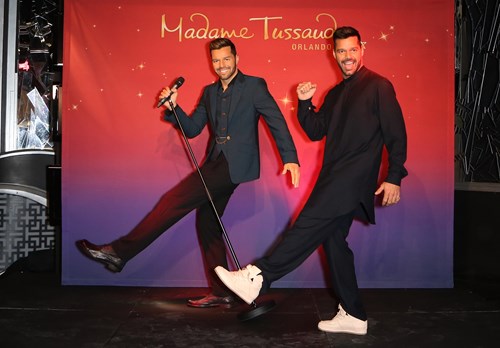 Ricky Martin posing next to his wax figure for Madame Tussauds Orlando