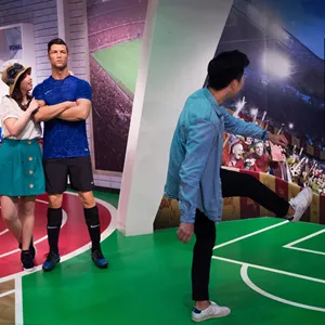 Visitors at Madame Tussauds Singapore Sports Zone taking pictures with the wax figure of footballer Cristiano Ronaldo. 